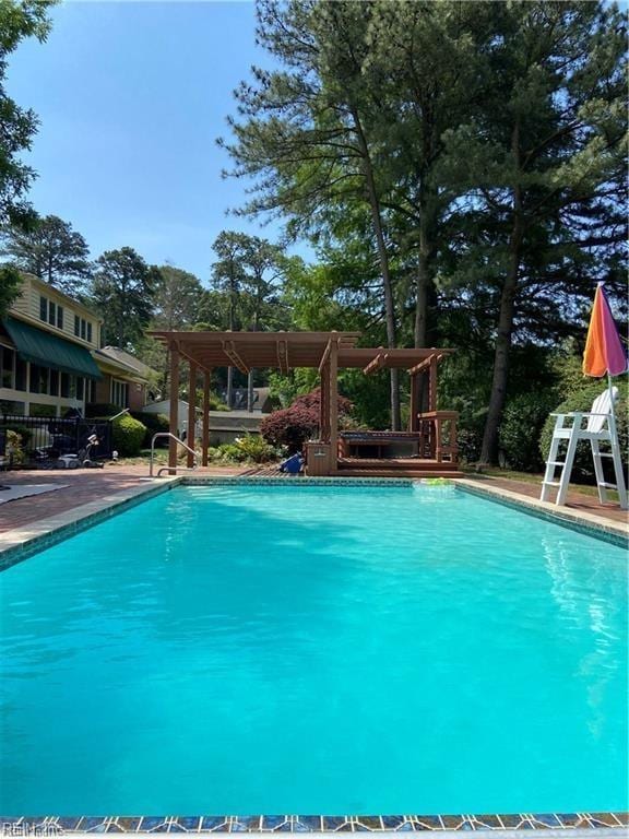 view of swimming pool featuring a pergola