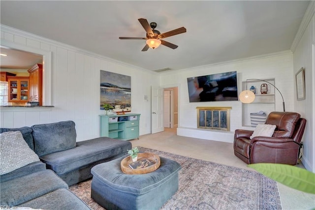 living room with ornamental molding, light carpet, and ceiling fan