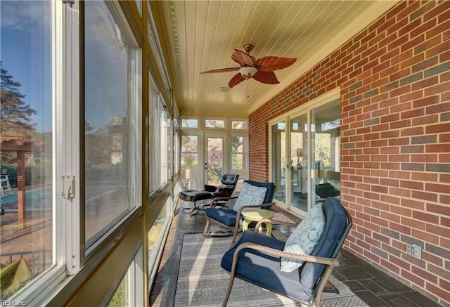 sunroom with wooden ceiling and ceiling fan