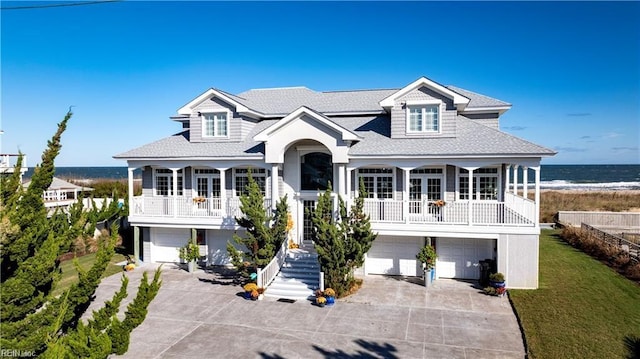 view of front of home with a garage, a front yard, concrete driveway, and stairway