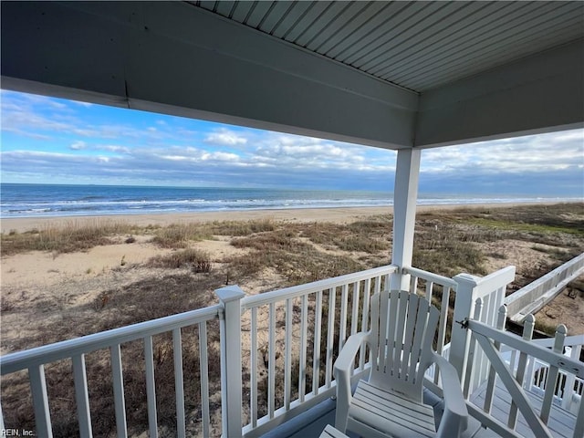 balcony with a beach view and a water view