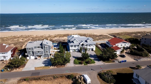 birds eye view of property with a beach view, a water view, and a residential view