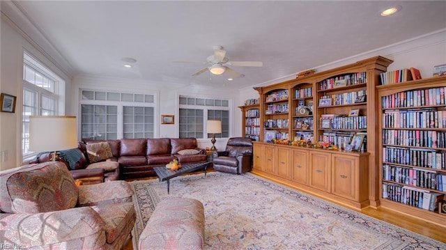 living room featuring ceiling fan, ornamental molding, and hardwood / wood-style floors