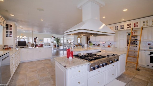 kitchen with white cabinets, dishwasher, island exhaust hood, stainless steel gas cooktop, and a kitchen island with sink