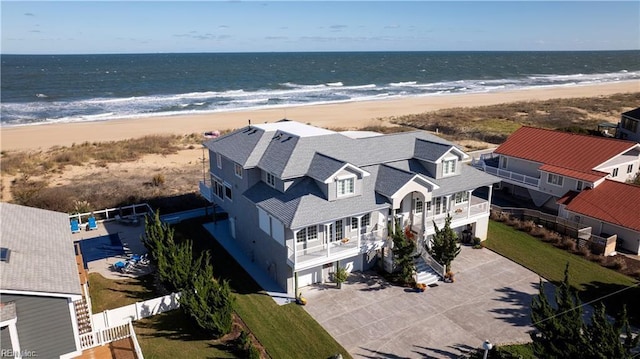 bird's eye view featuring a water view and a beach view