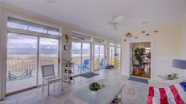 unfurnished sunroom featuring ceiling fan