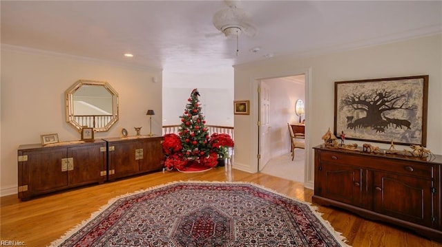 interior space featuring ornamental molding and light hardwood / wood-style flooring