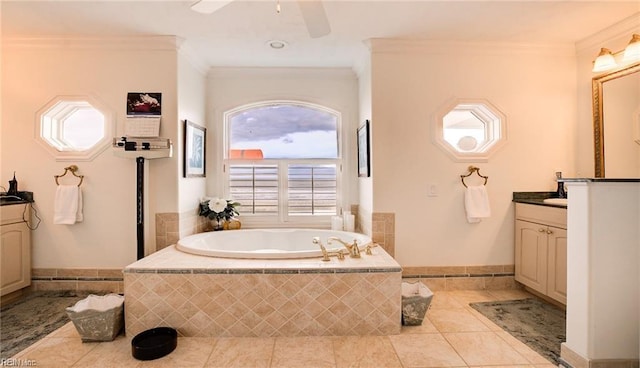 bathroom with vanity, a wealth of natural light, crown molding, and tiled tub