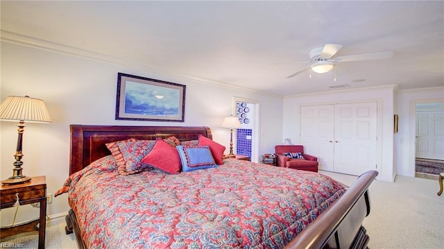 bedroom with ceiling fan, light colored carpet, a closet, and ornamental molding