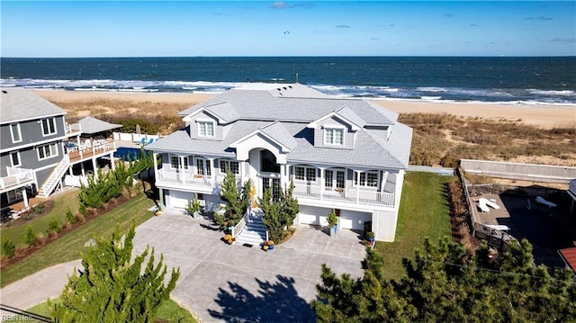 drone / aerial view featuring a water view and a beach view