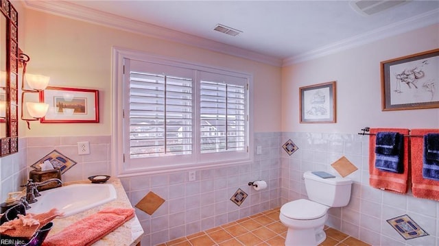 bathroom featuring toilet, ornamental molding, tile walls, and tile patterned floors