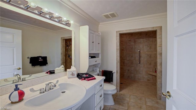 bathroom with toilet, vanity, tile patterned floors, crown molding, and a tile shower