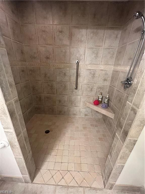 bathroom with a tile shower