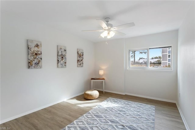 living area featuring ceiling fan and hardwood / wood-style floors