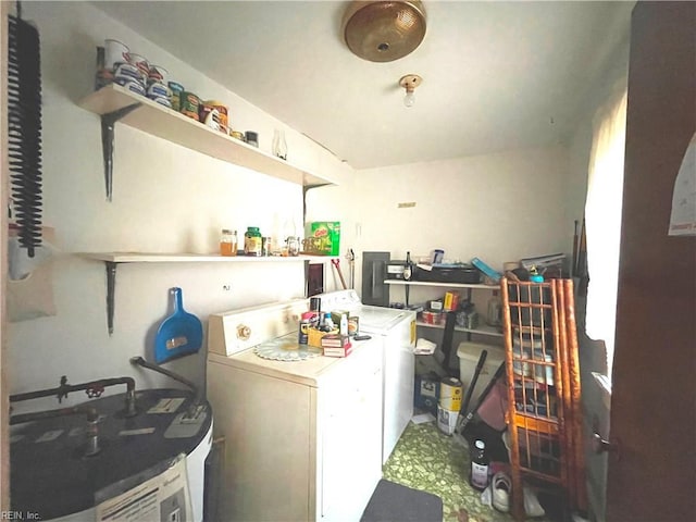 laundry area with washer and clothes dryer and water heater