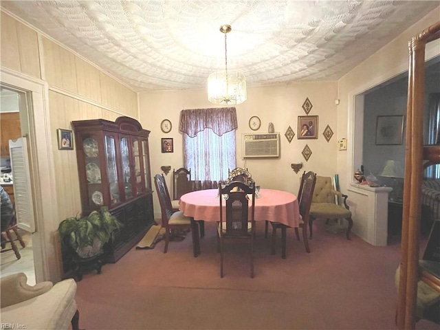 dining area featuring carpet floors, a textured ceiling, a notable chandelier, and a wall mounted air conditioner