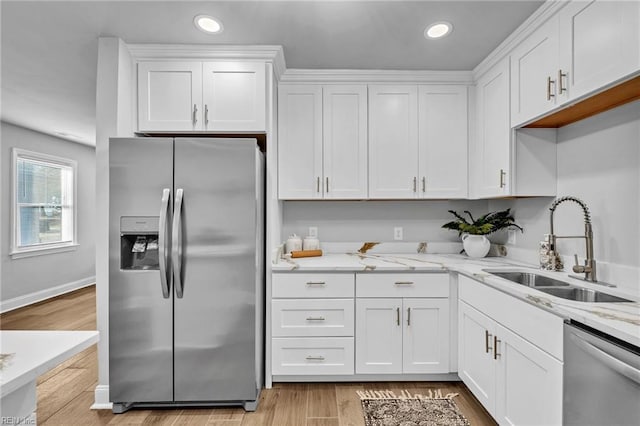 kitchen featuring appliances with stainless steel finishes, sink, and white cabinetry