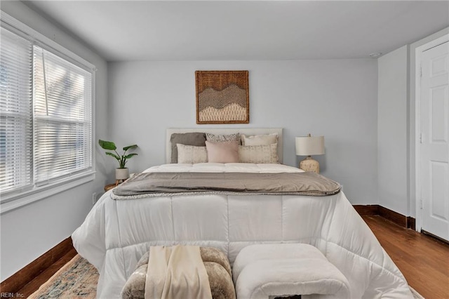 bedroom with dark wood-type flooring