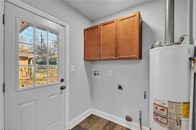 clothes washing area with gas water heater, washer hookup, dark hardwood / wood-style flooring, hookup for an electric dryer, and cabinets