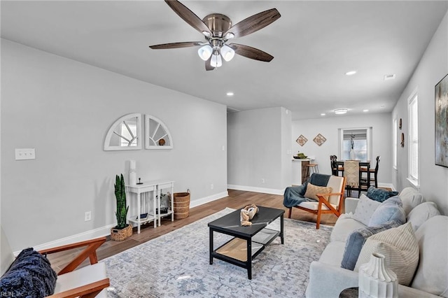 living room with ceiling fan and wood-type flooring