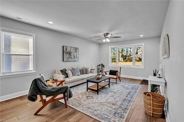 living room with hardwood / wood-style flooring, ceiling fan, and a healthy amount of sunlight