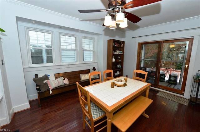 dining room with ceiling fan, dark hardwood / wood-style flooring, ornamental molding, and french doors