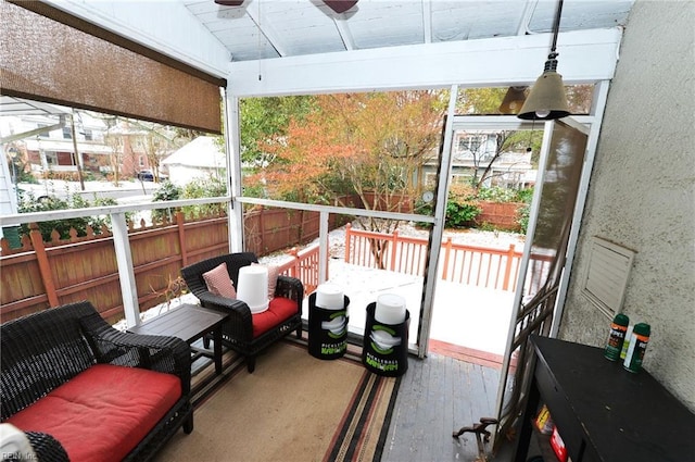 sunroom / solarium featuring ceiling fan and vaulted ceiling