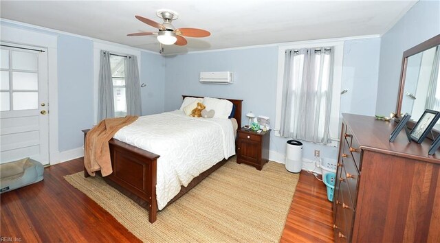 bedroom featuring a wall unit AC, ceiling fan, ornamental molding, and wood-type flooring