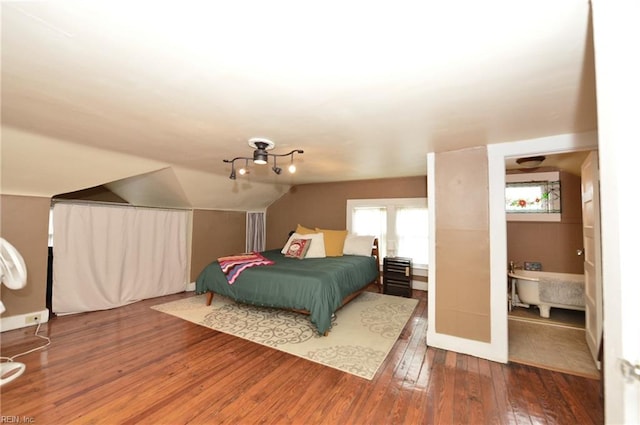 bedroom featuring lofted ceiling and hardwood / wood-style flooring