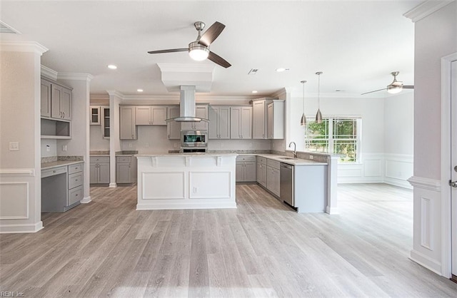 kitchen with island exhaust hood, appliances with stainless steel finishes, hanging light fixtures, crown molding, and a center island