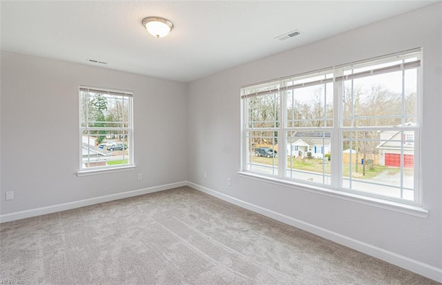 unfurnished room with light carpet