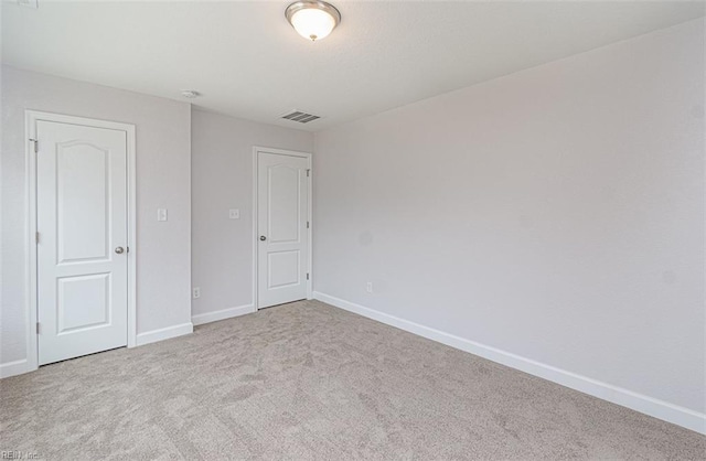 unfurnished bedroom with light colored carpet