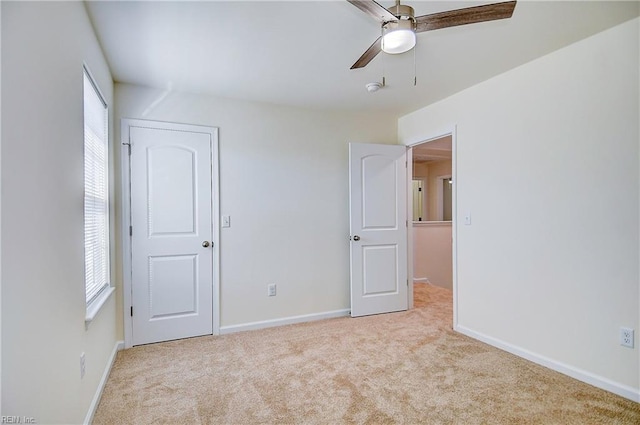 unfurnished bedroom featuring ceiling fan and light carpet