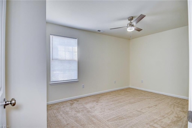 carpeted spare room with ceiling fan