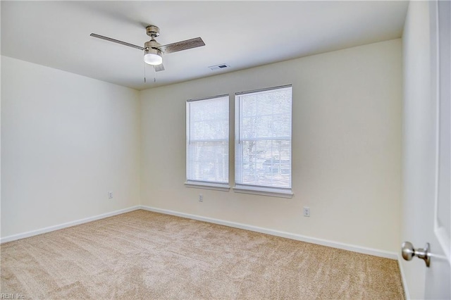 carpeted spare room with ceiling fan