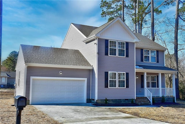 view of property with covered porch and a garage