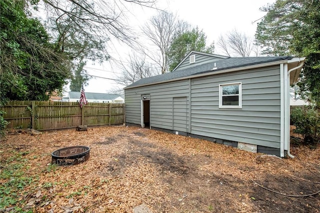 view of outbuilding with a fire pit