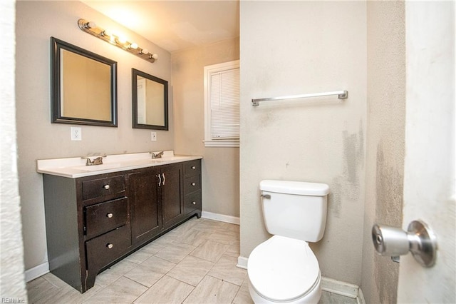 bathroom with toilet and vanity