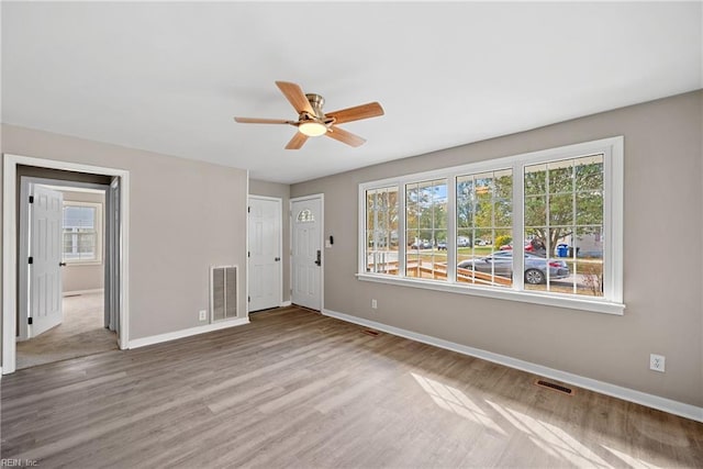 unfurnished room featuring ceiling fan and hardwood / wood-style floors