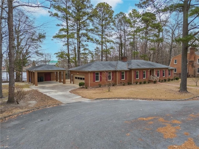 ranch-style home with a garage and a carport