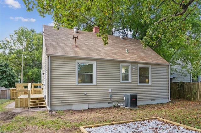 back of house featuring central AC and a wooden deck