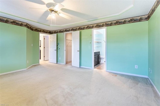 spare room featuring ceiling fan, a textured ceiling, and carpet flooring