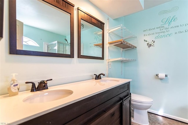 bathroom with toilet, vanity, and an enclosed shower