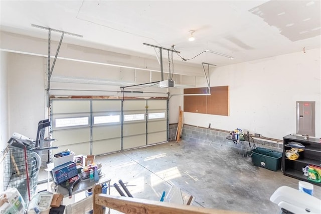 garage with a garage door opener and electric panel