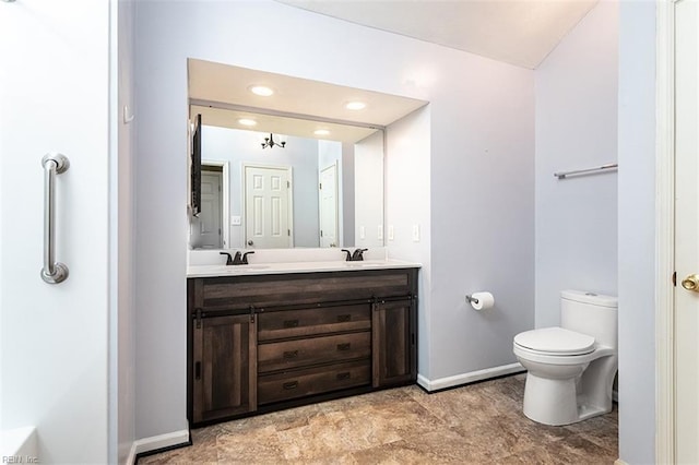 bathroom featuring toilet and vanity