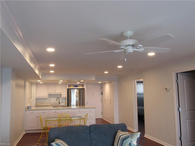 living room featuring ceiling fan, dark hardwood / wood-style flooring, sink, and ornamental molding