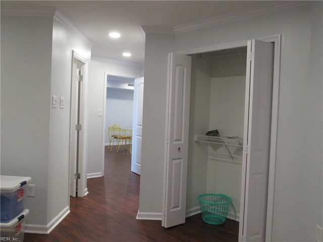 corridor featuring dark hardwood / wood-style floors and crown molding