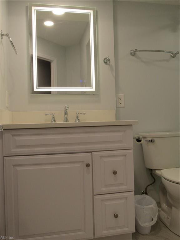 bathroom with toilet and vanity