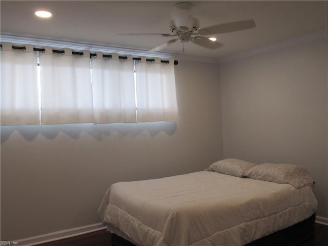 bedroom featuring ceiling fan, dark wood-type flooring, and crown molding