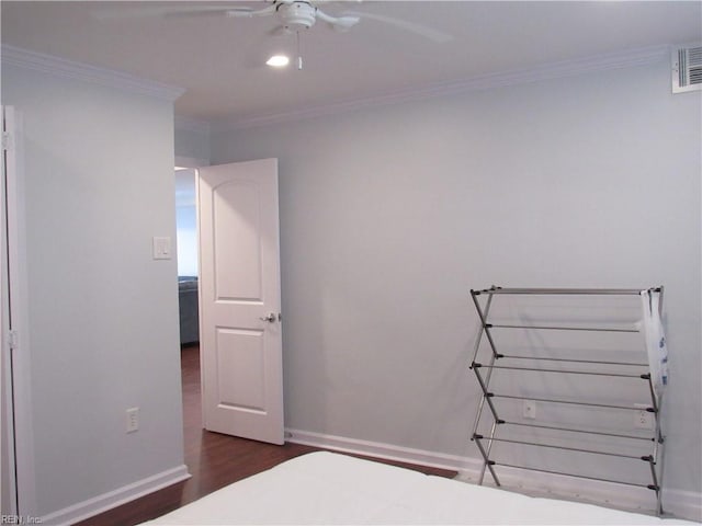 unfurnished bedroom featuring ceiling fan, dark hardwood / wood-style flooring, and ornamental molding